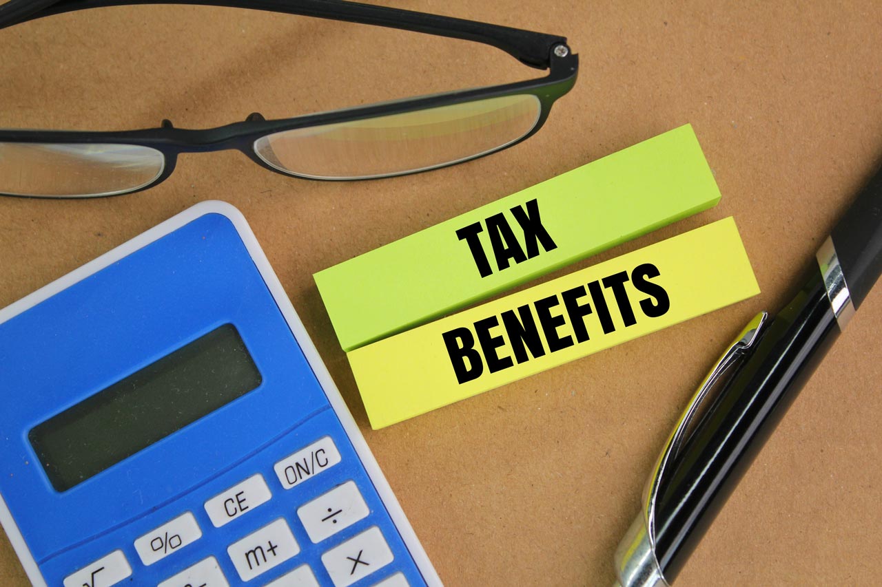 Tax benefits concept with calculator, glasses, and pen on a desk. Financial planning for Social Security benefits.